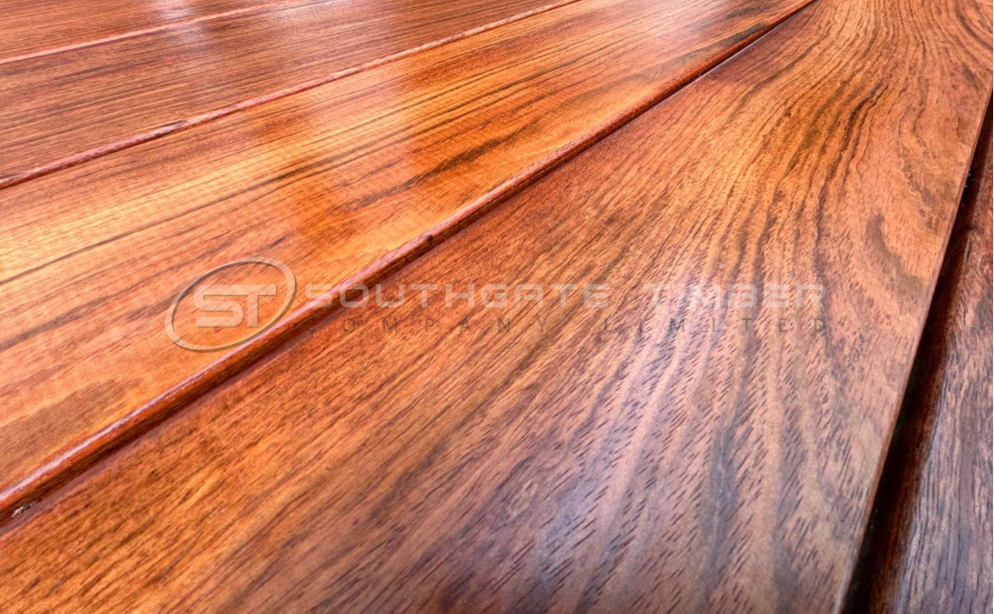 Close-up of Jatoba 21 x 145mm grooved hidden-fix decking treated with Owatrol Textrol oil, showing the rich reddish-brown tones and smooth grain finish supplied by Southgate Timber.